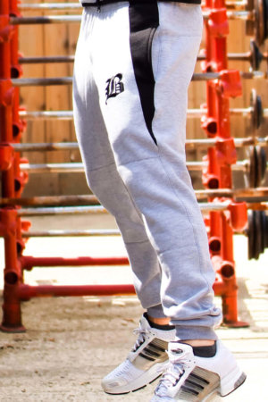 Light grey and black technical tracksuit bottoms by Berserker Apparel gym wear that fits is comfortable and looks awesome